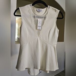 New bebe peplum off white blouse size S with with see-through V lace neckline.